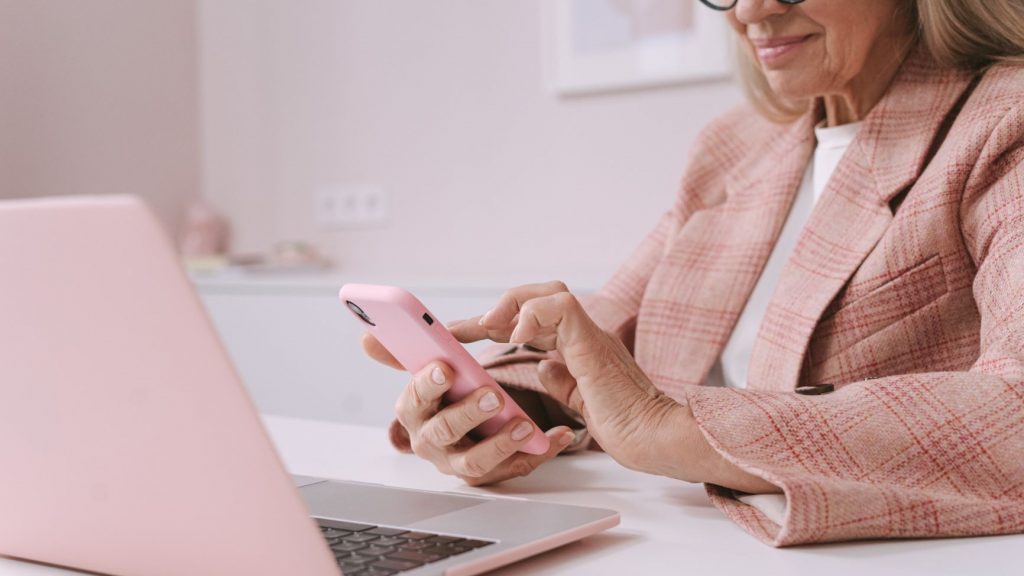 woman in pink checking her email