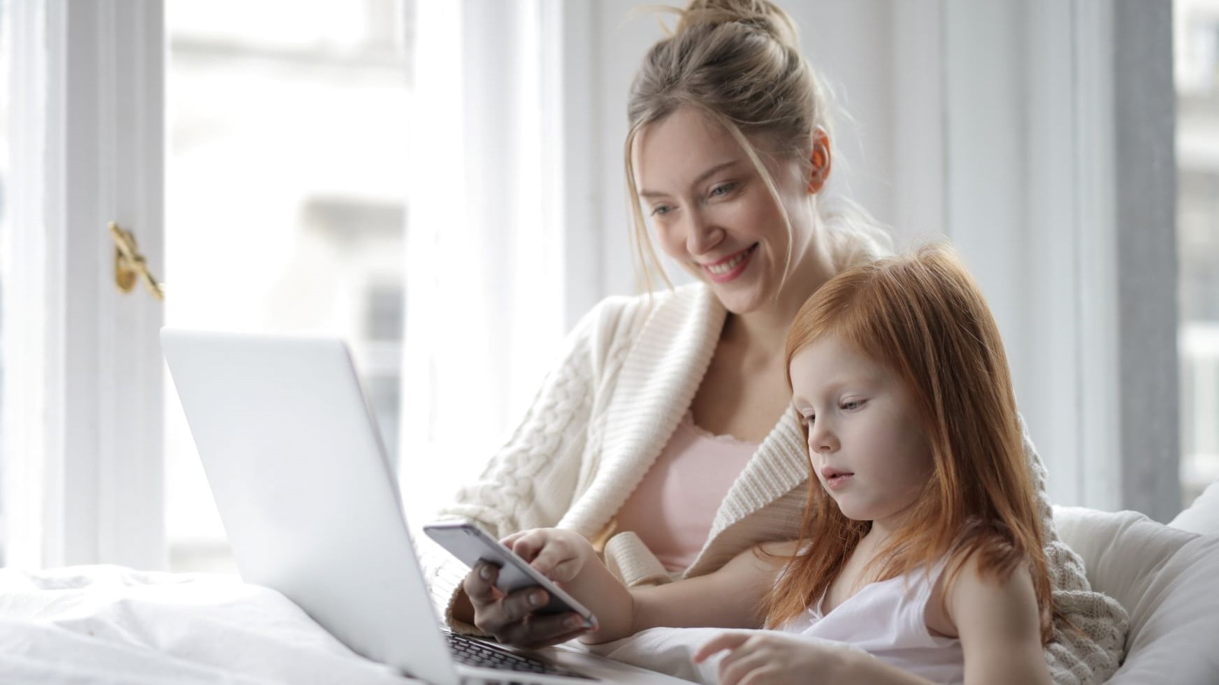 mom working from home with her daughter