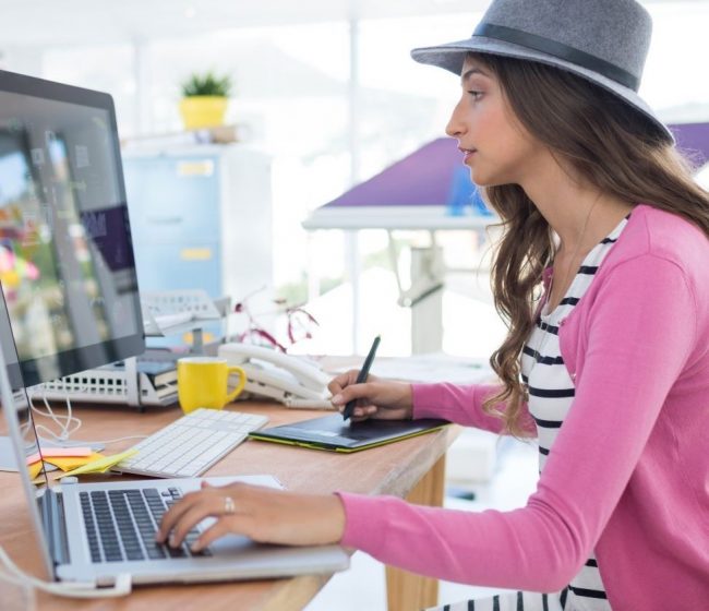 woman graphic designer sitting in a yellow chair