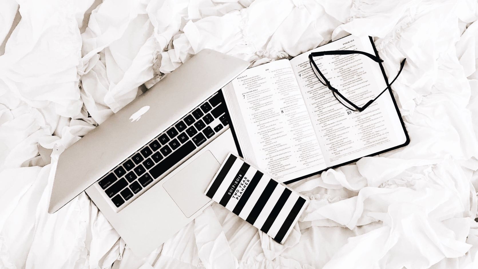 graphic design tools on a white bed