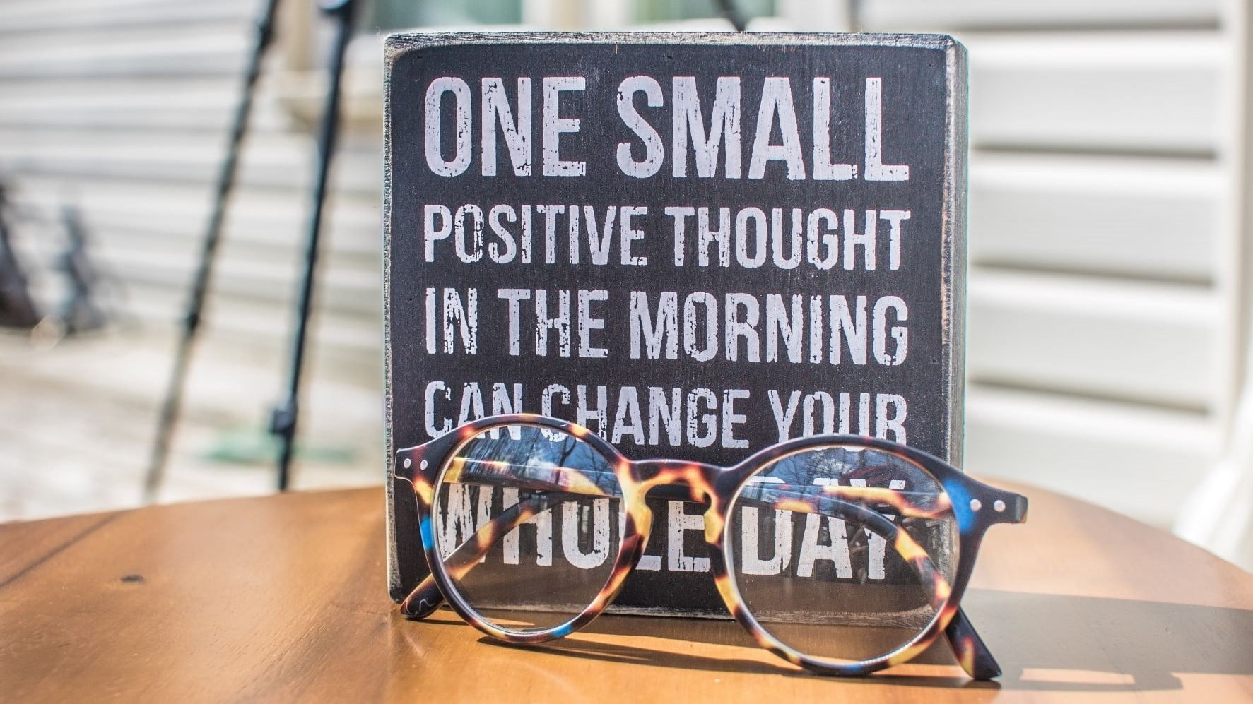 glasses and a positive sign on a desk