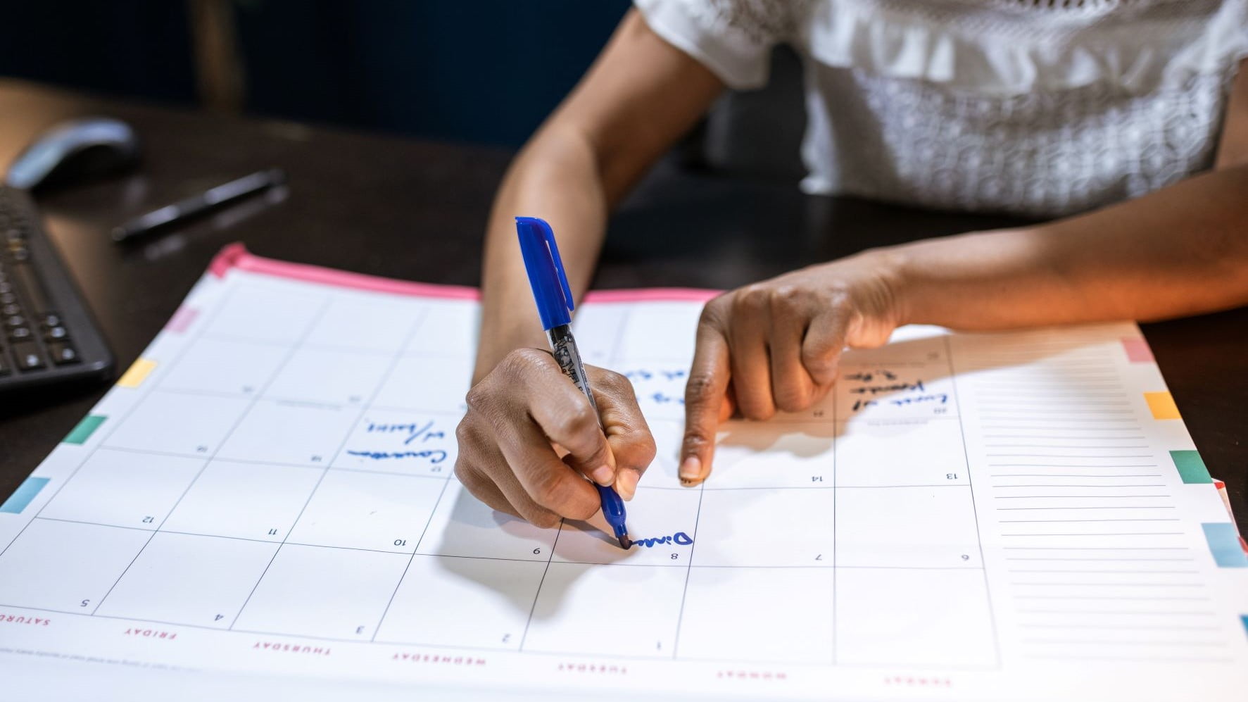 graphic designer writing in a planner