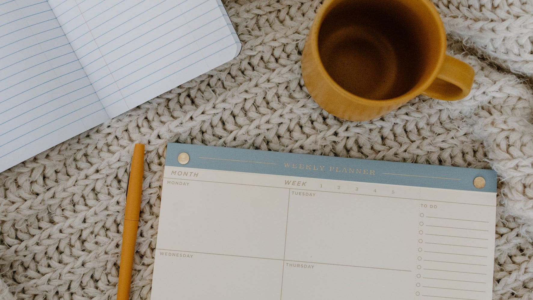paper calendar next to a mug of tea