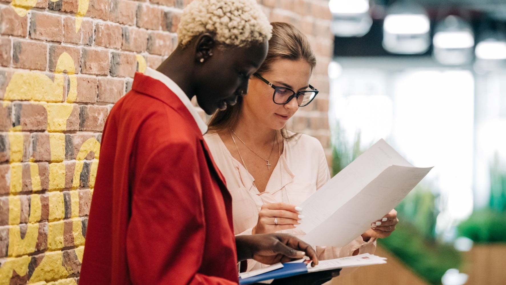 two freelance web designers looking at a paper