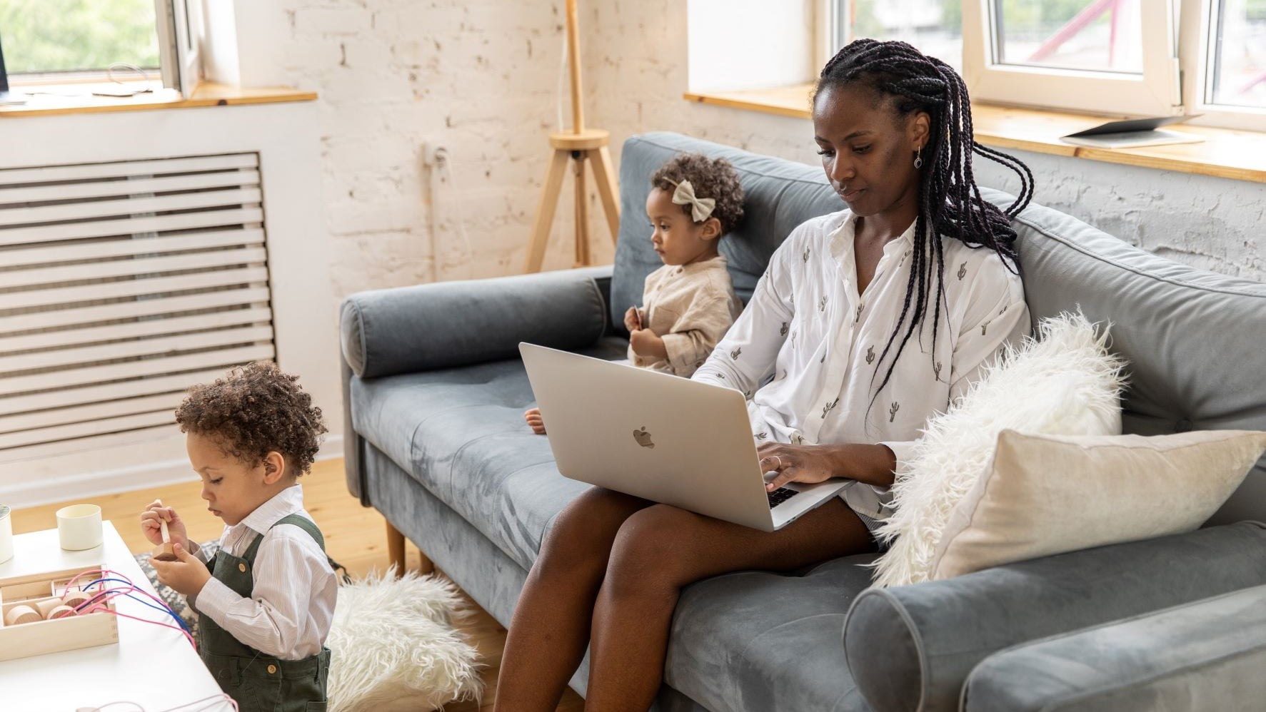 woman starting freelance design work with her kids at home