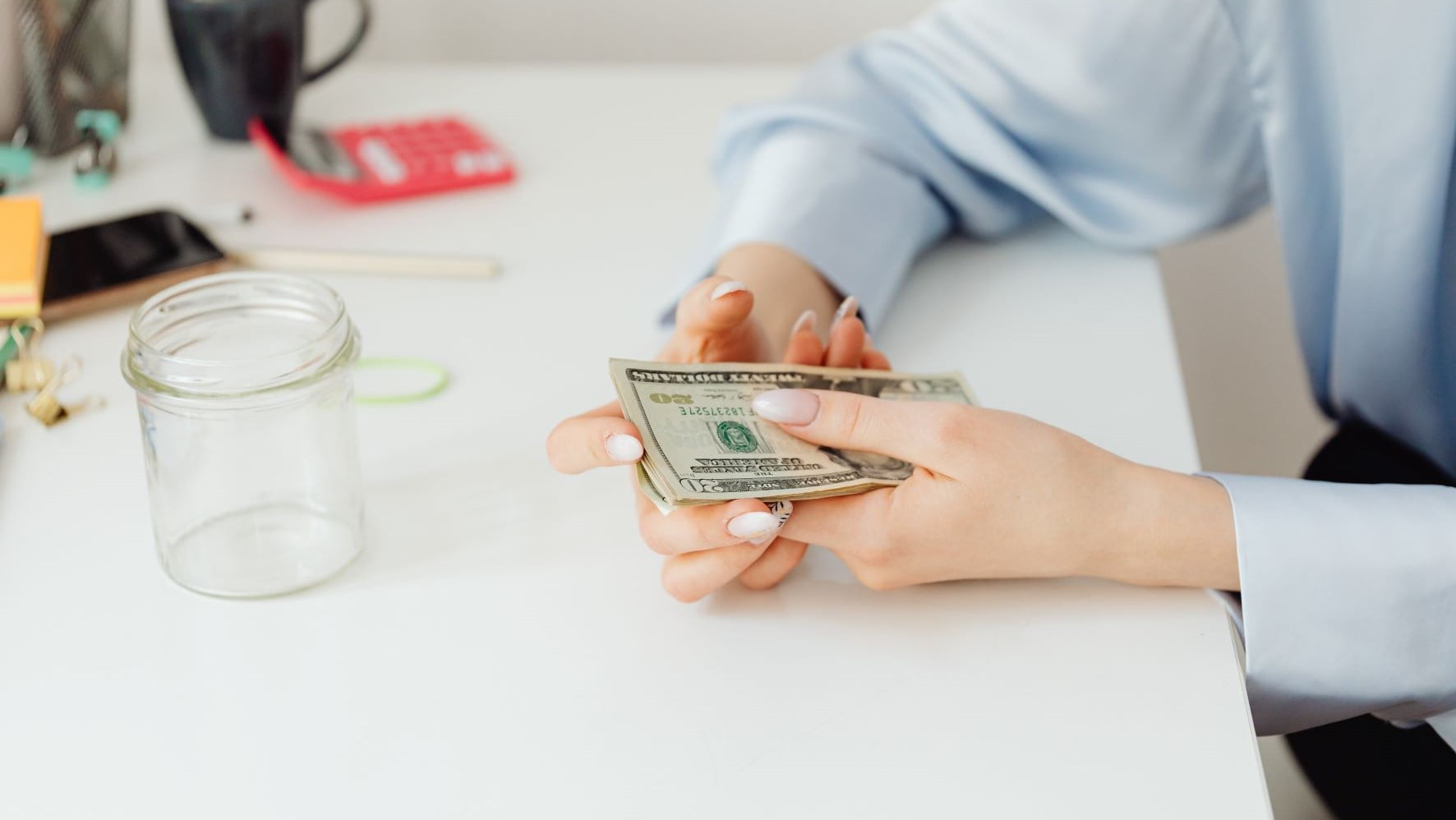 freelance brand designer holding cash