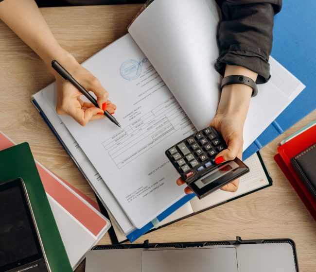 web designer holding a calculator