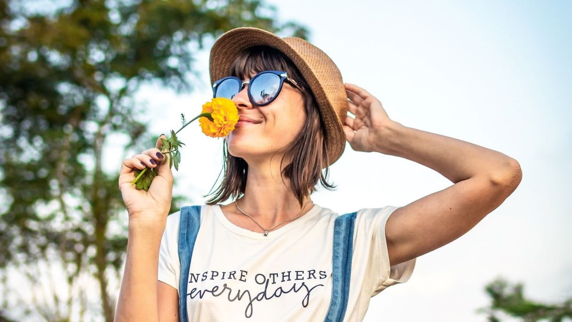branding designer smelling yellow flowers