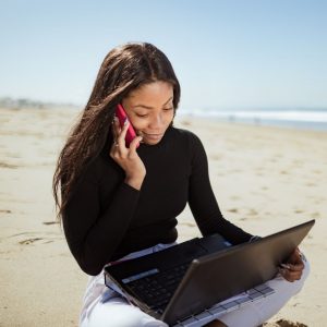 freelance web designer working on the beach