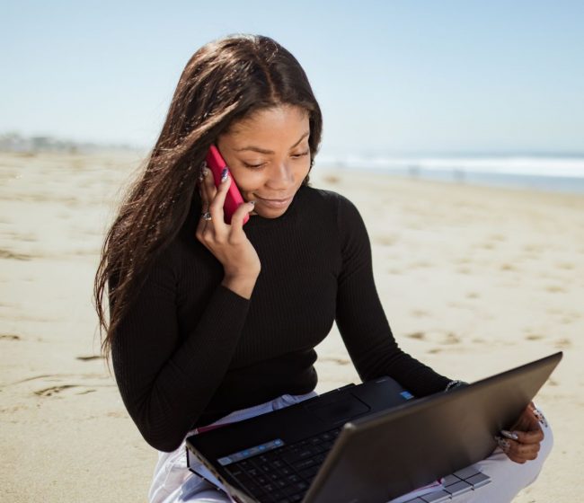 freelance web designer working on the beach