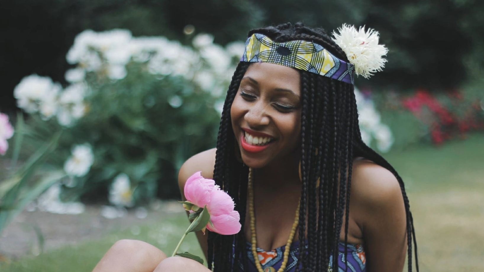 freelance web designer smelling a flower