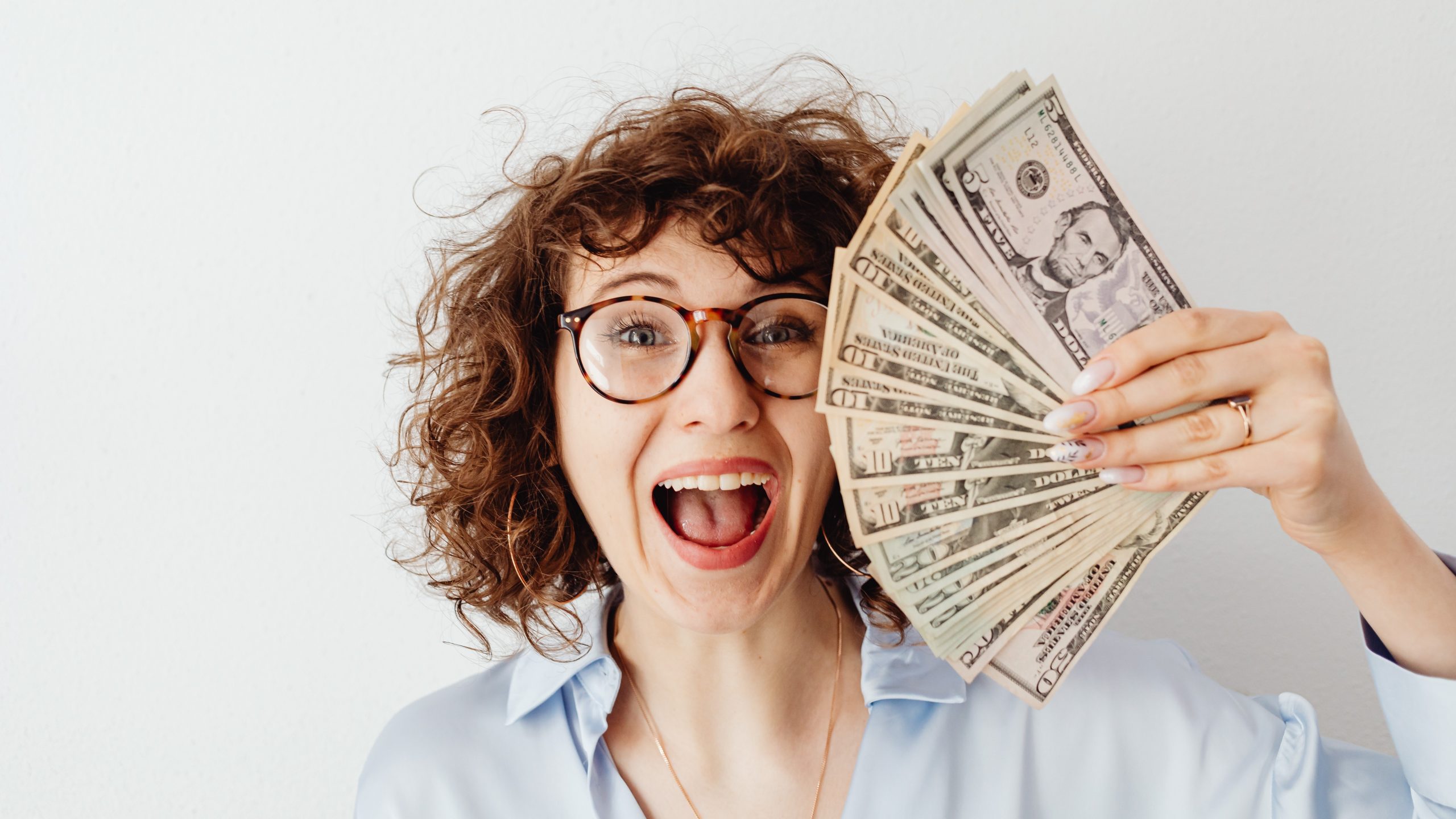 freelance brand designer holding money