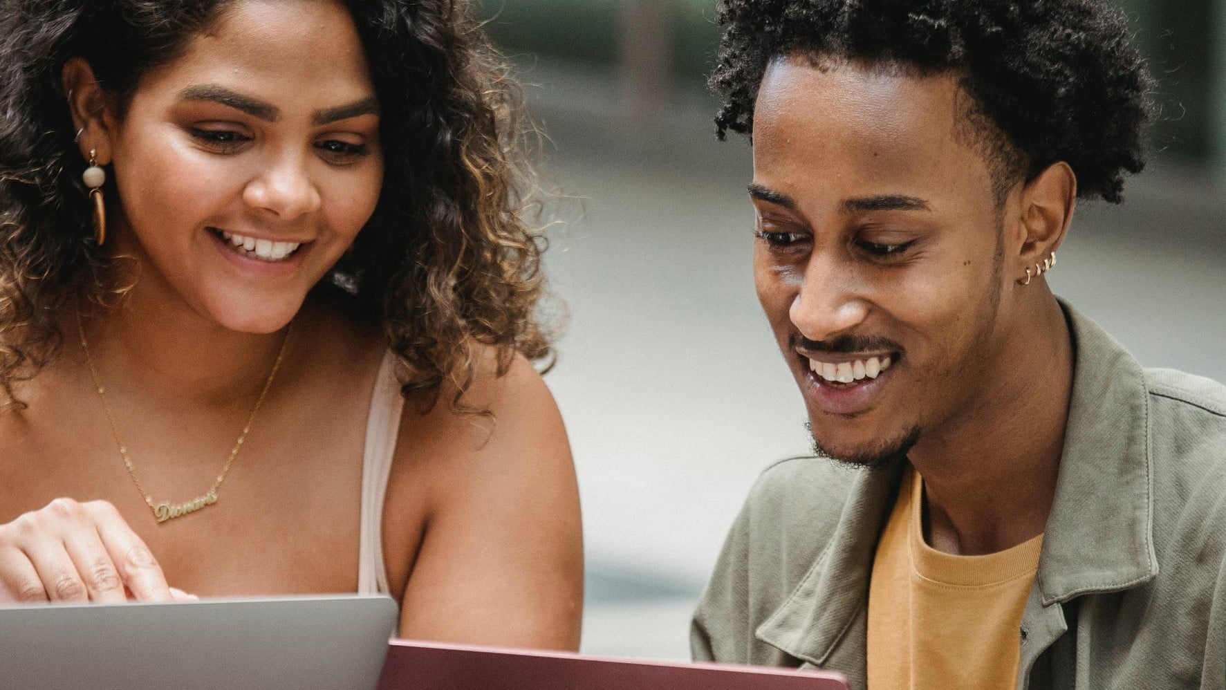 two brand designers working on laptops
